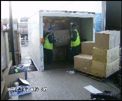 Volunteers load a truck with blankets and warm clothing.