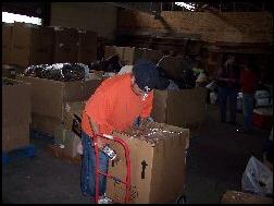 A volunteer prepares a box.