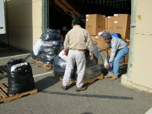 Volunteers loading pallet.